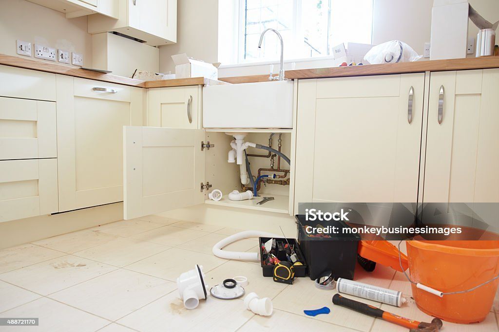 Plumbers tools and equipment on a kitchen floor
